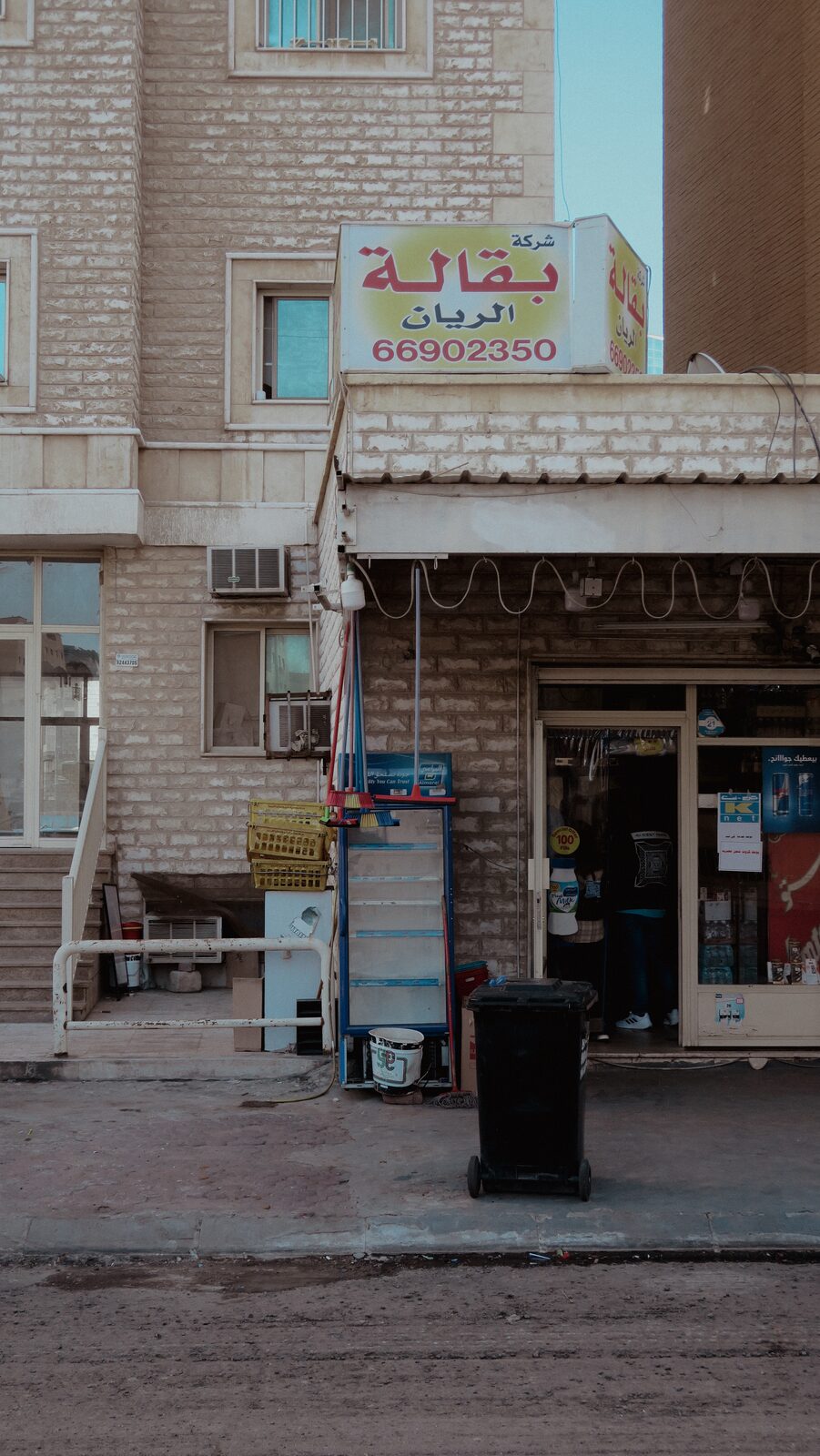 Small grocery storefront beneath apartments — Bashar Belal for ZELZAL