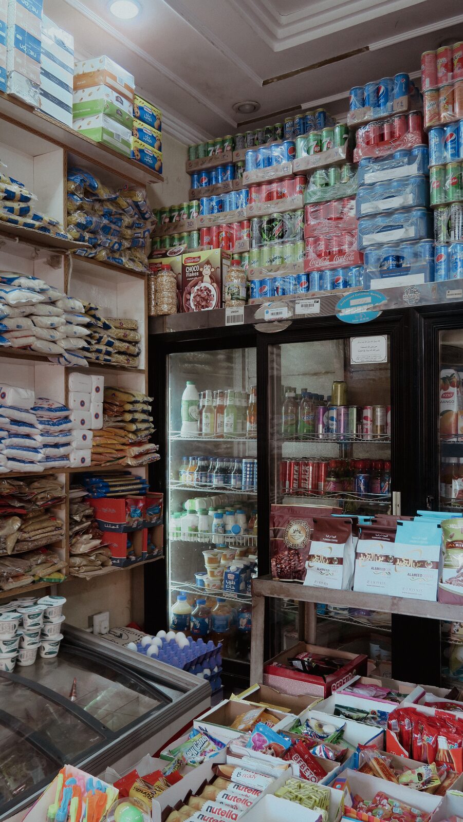 Interior of a crowded grocery shop — Bashar Belal for ZELZAL