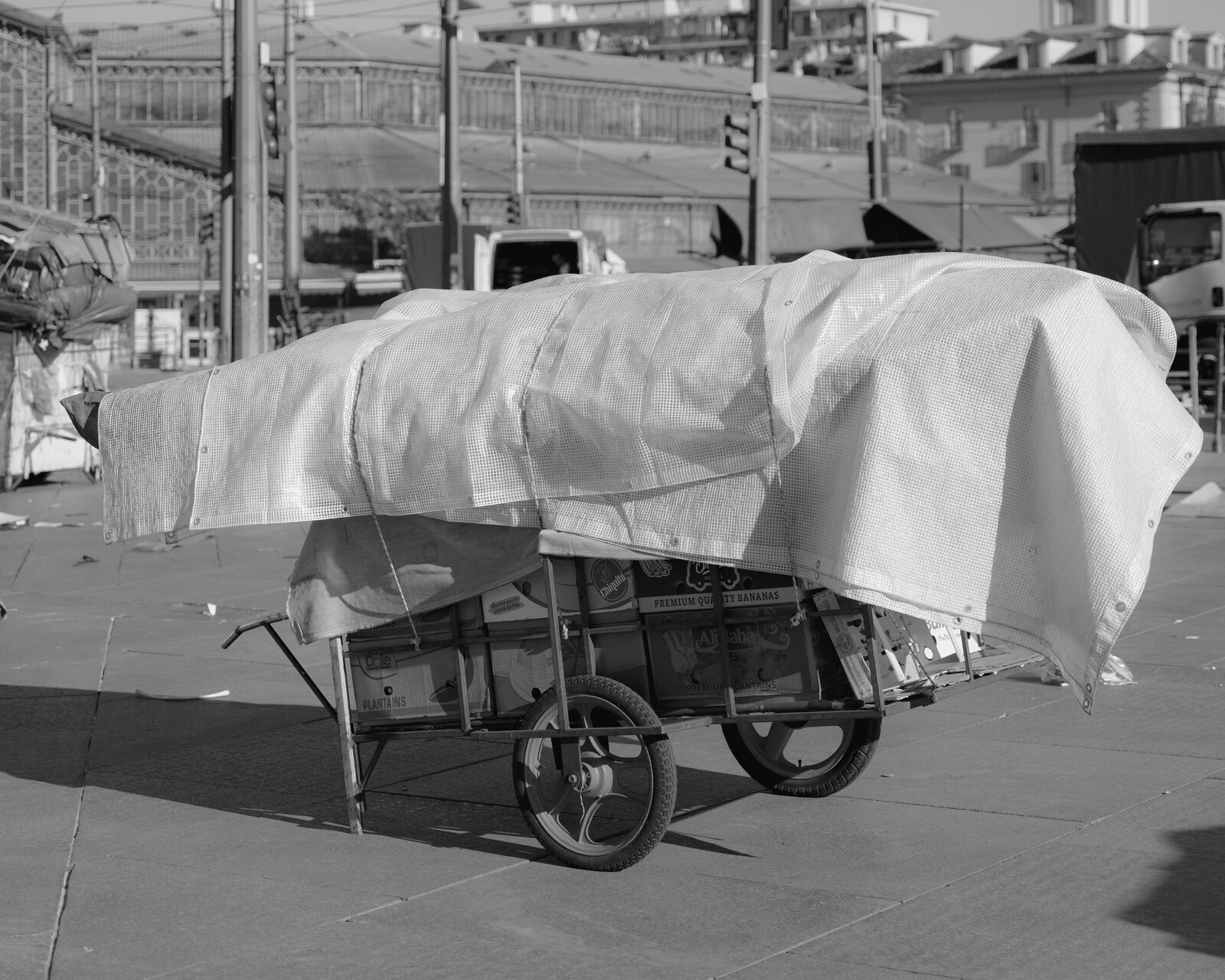 Black-and-white cart covered in a white tarp — Karim El Maktafi for ZELZAL