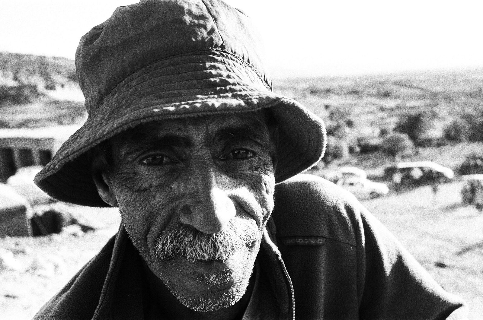 Black-and-white portrait of a man in a bucket hat — Lara Perrotte for ZELZAL