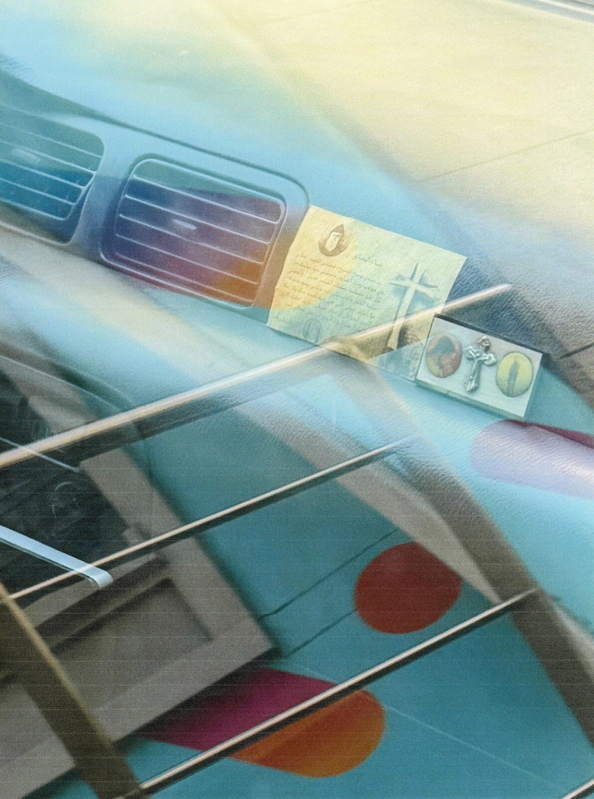 Layered colour image of a car dashboard with charms — Mariam El Gendy for ZELZAL