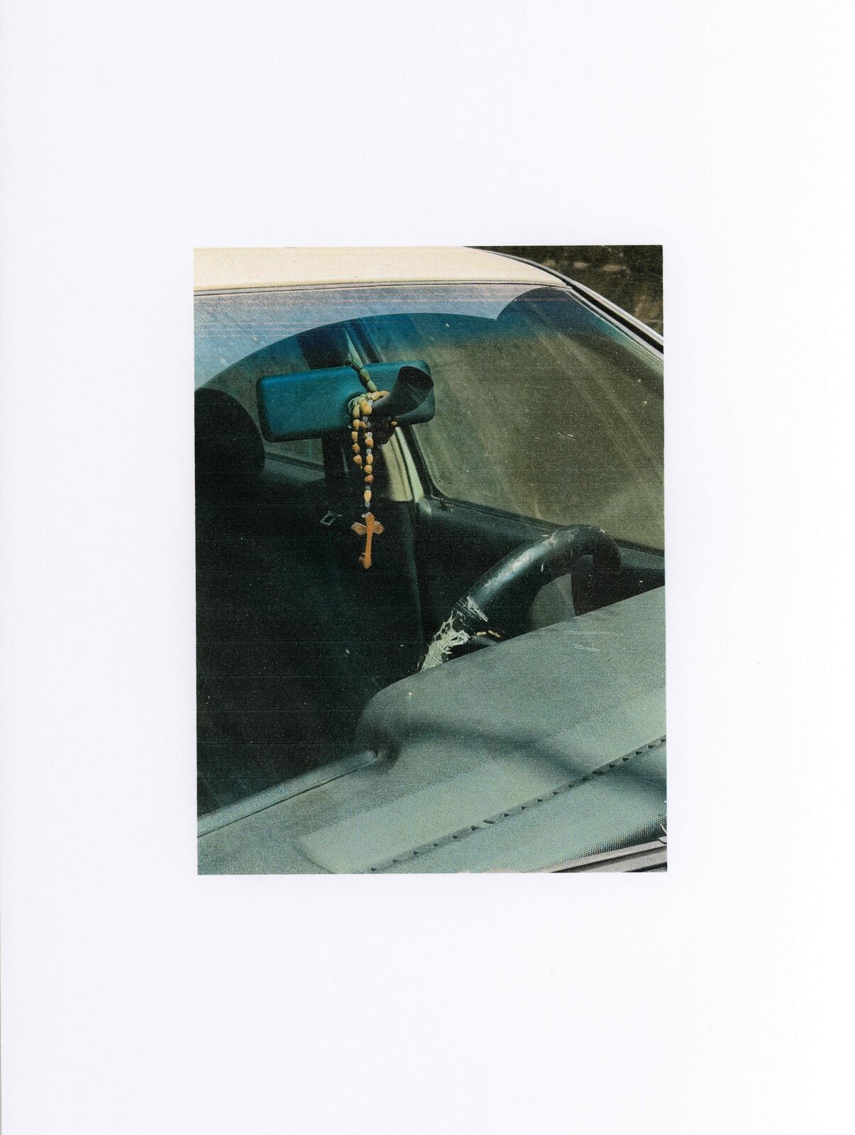 Scanned print of a rosary hanging in a car — Mariam El Gendy for ZELZAL