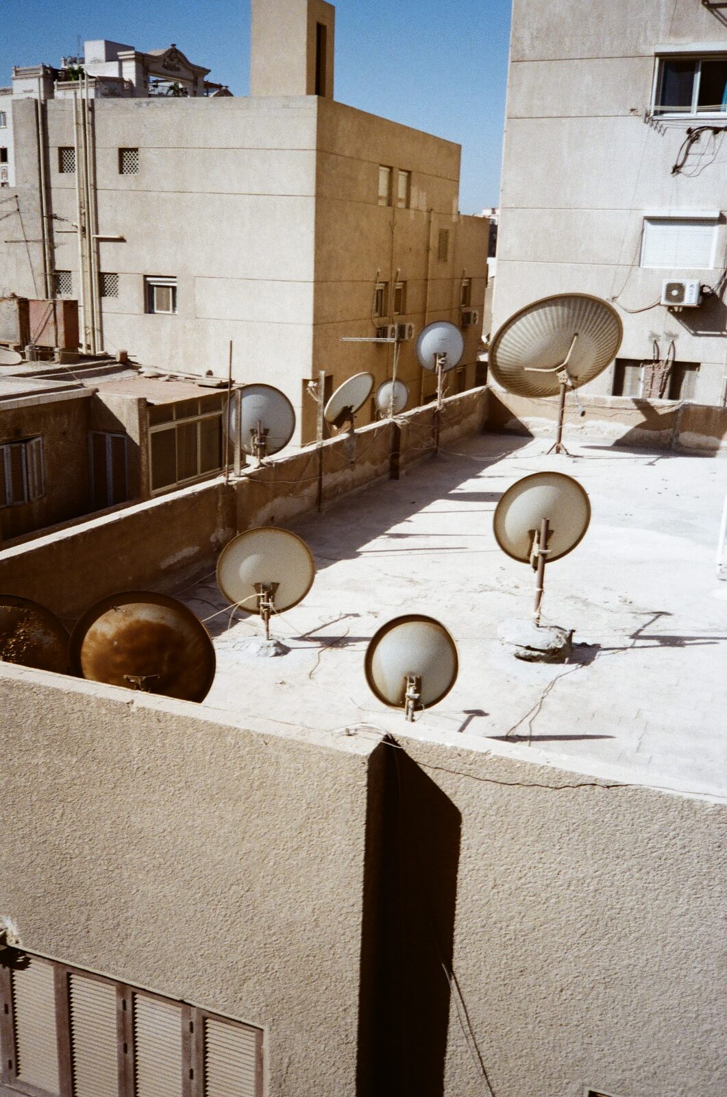 Rooftops with satellite dishes — Omar Abulata for ZELZAL