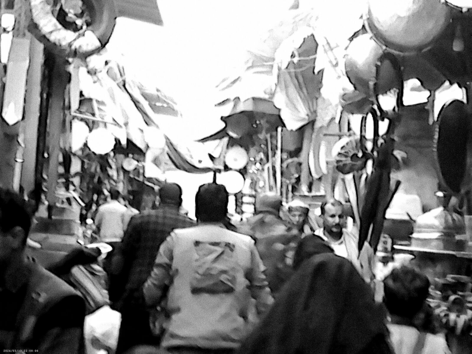 Black-and-white crowded market street — Sadiq Y. Al-Harasi for ZELZAL