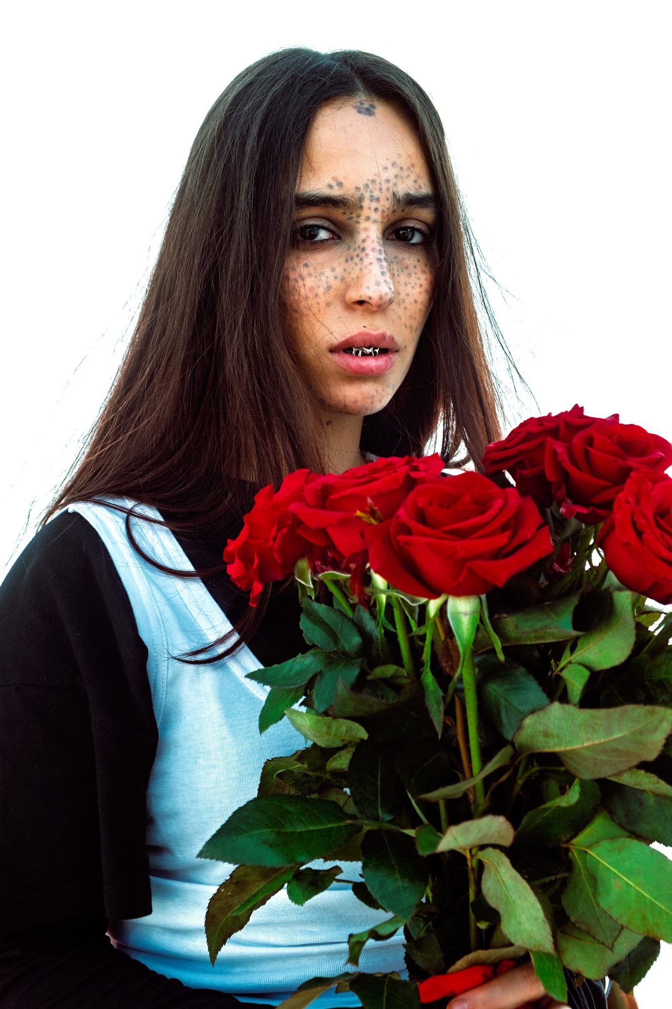 SOFT HEAT: woman with face jewels holding red roses