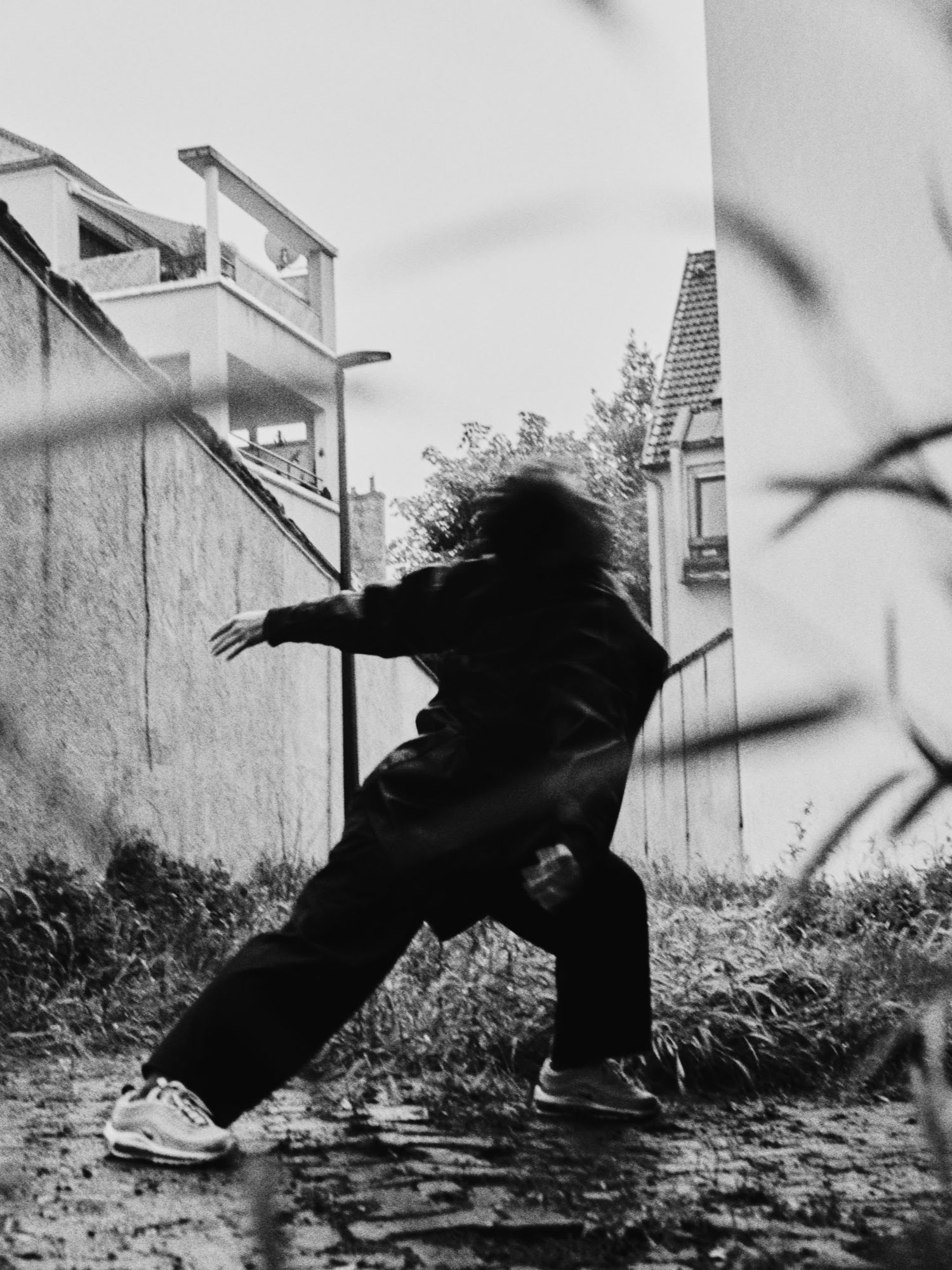 CYPHER: b-boy mid-move by tall grass