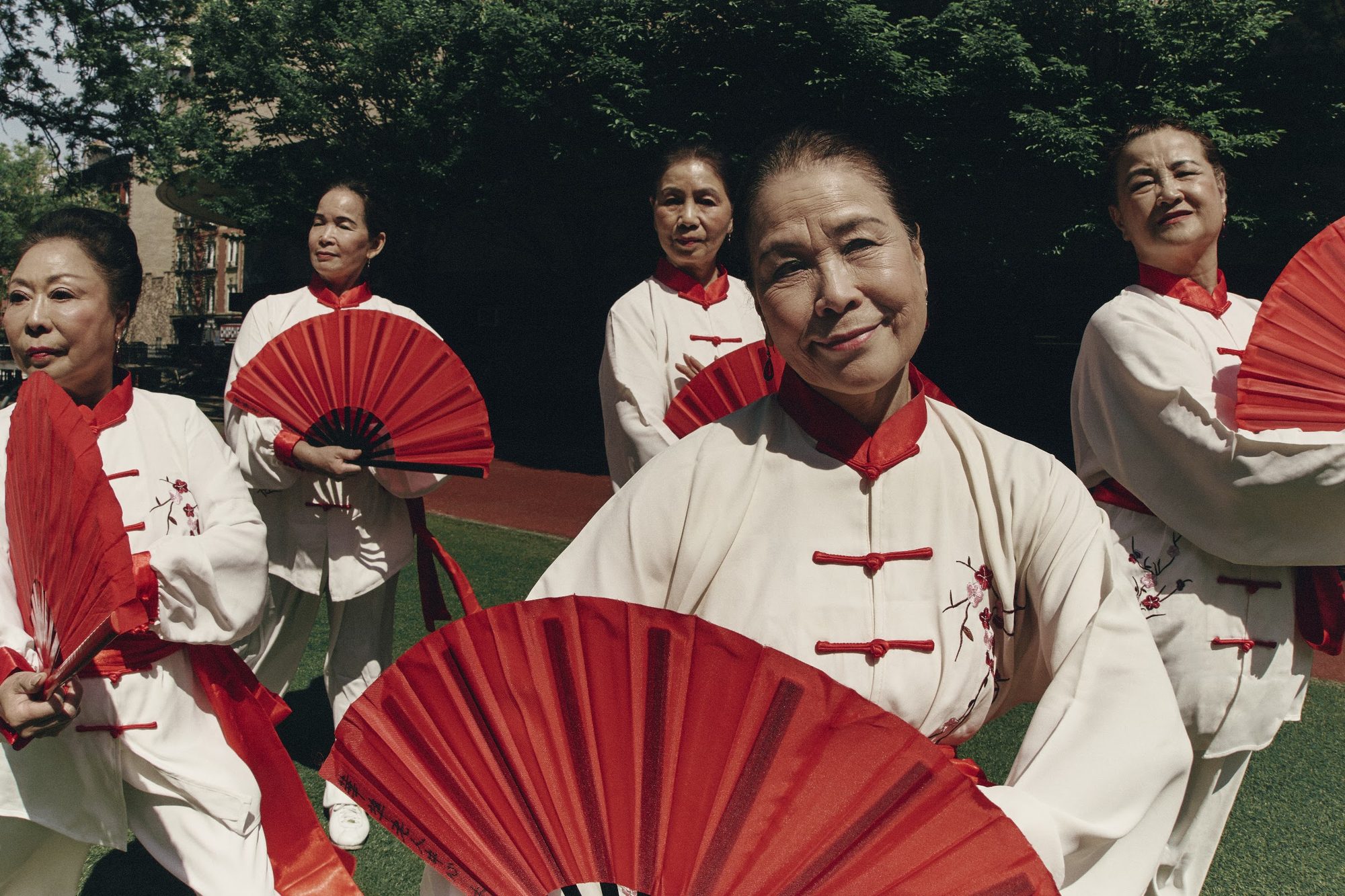 SLOW DAWN: elders with red fans
