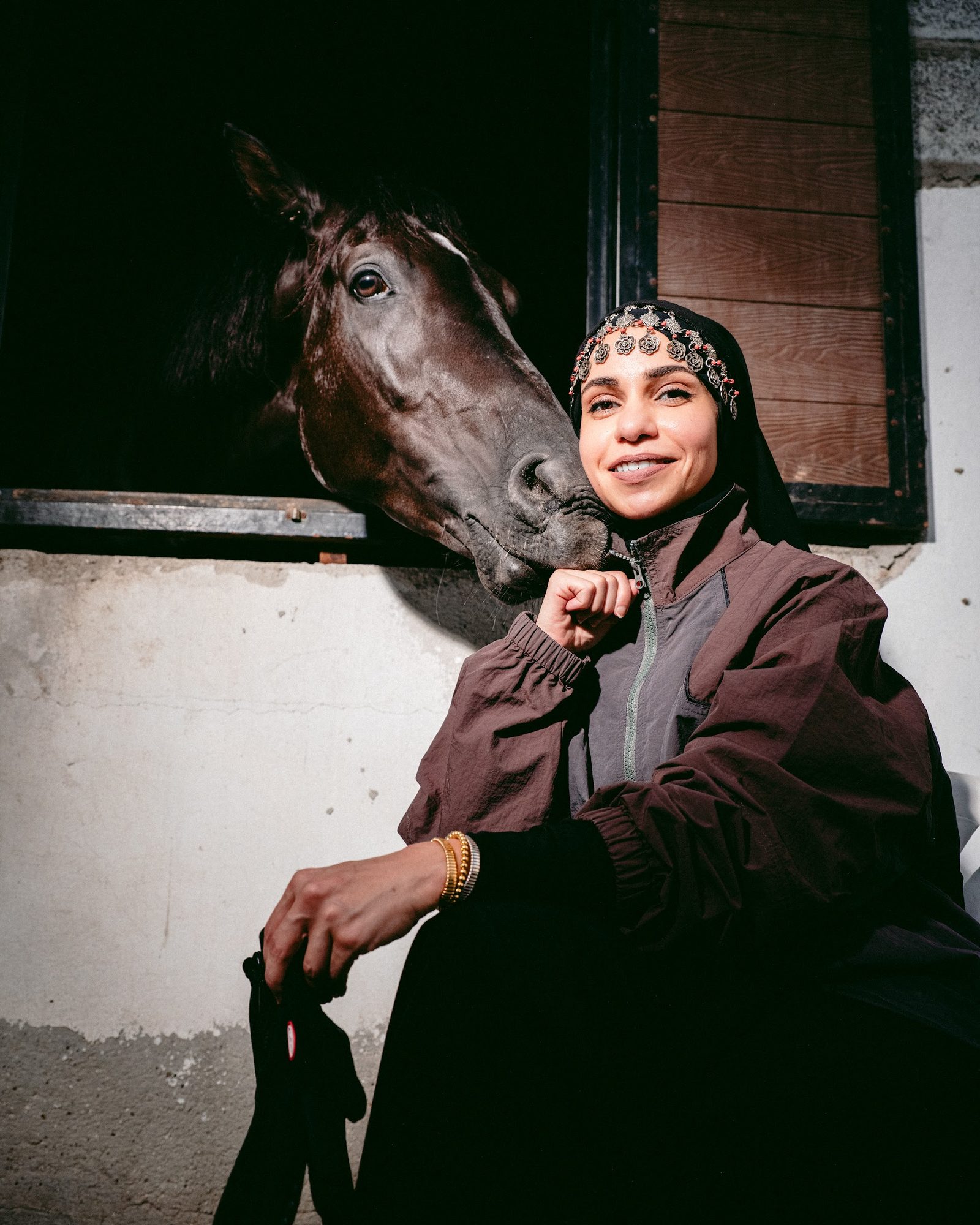 THE CHARGE: rider in a stable doorway with a horse